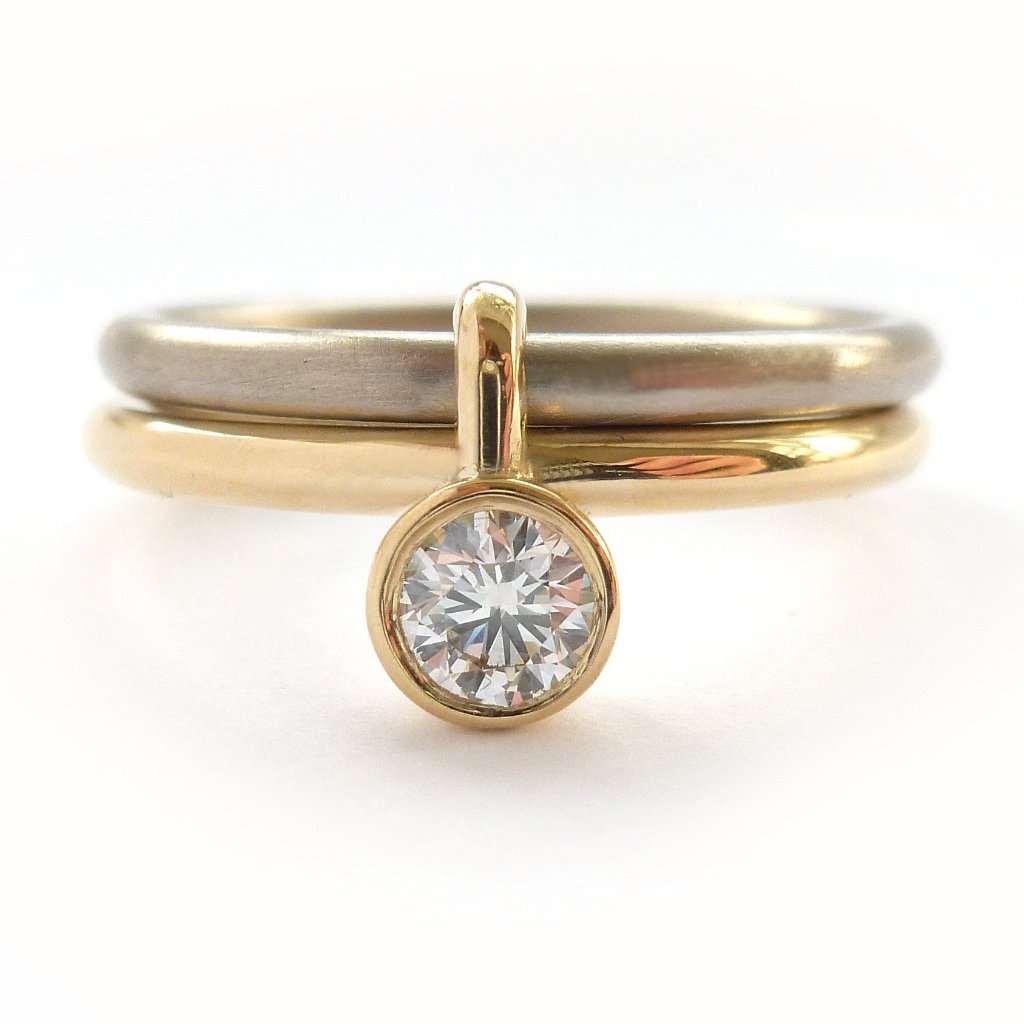 A unique modern contemporary 18ct gold two tone stacking engagement ring with white diamond. Multi band ring or interlocking ring, sometimes called double band ring too.