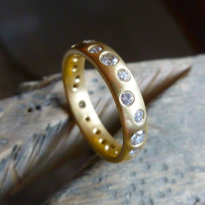 A modern unique eternity ring with 20 diamonds. Beautiful contemporary wedding, eternity or engagement ring.