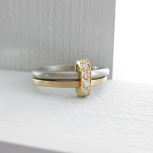 Modern and bespoke two band two tone ring with pave set diamonds. Modern, unique two band ring joined together with diamonds. An alternative eternity or wedding ring. Multi band ring or interlocking ring, sometimes called double band ring too.