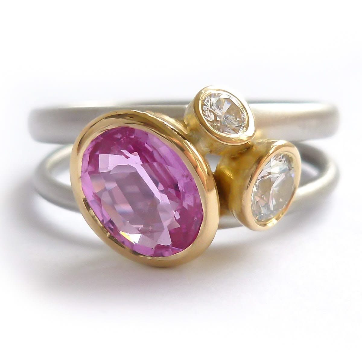 Platinum, 18ct gold, pink sapphire and two white diamonds ring. Contemporary, modern and unique.