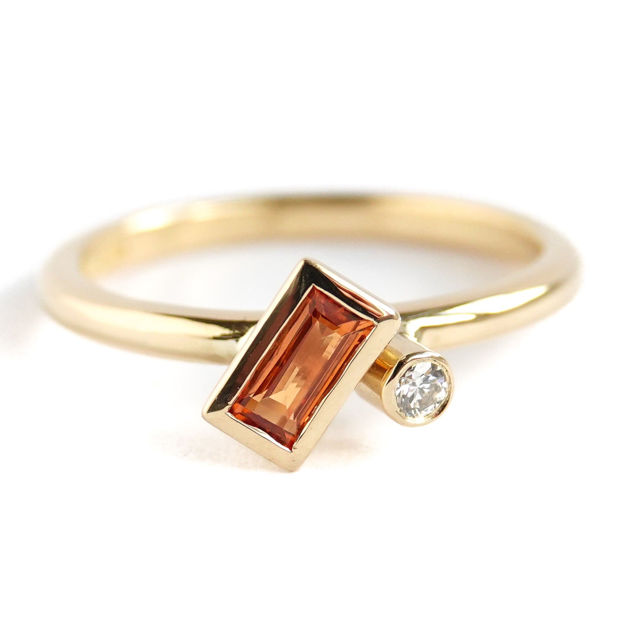 A bespoke orange sapphire and diamond 18ct gold ring. Contemporary and unique.