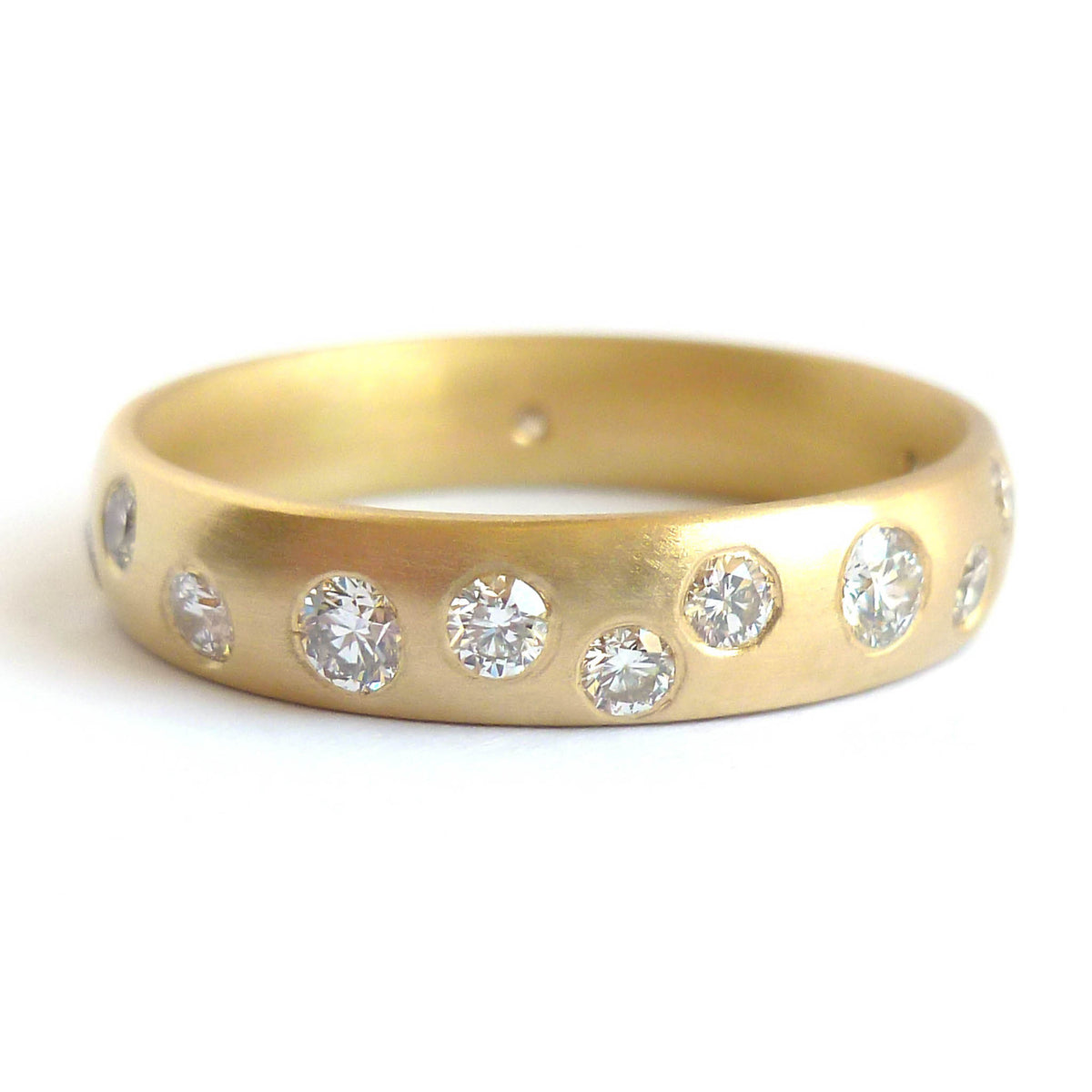 A modern unique eternity ring with 20 diamonds. Beautiful contemporary wedding, eternity or engagement ring.