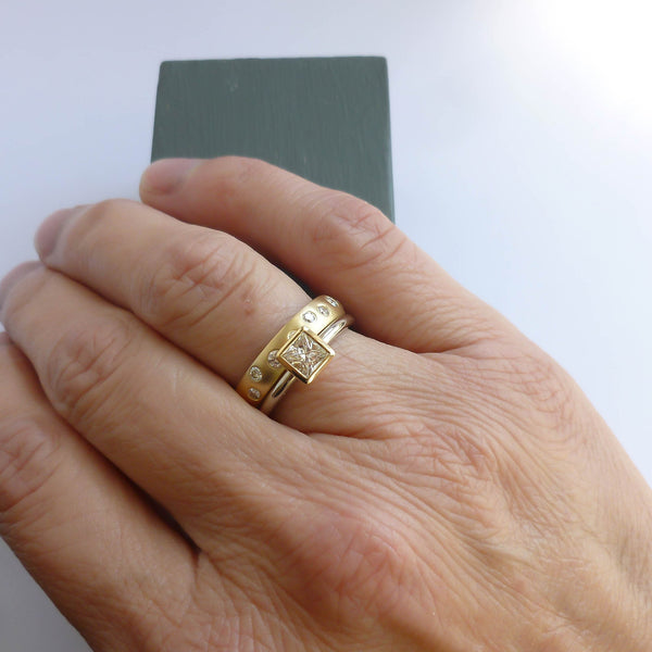 A modern unique eternity ring with 20 diamonds. Beautiful contemporary wedding, eternity or engagement ring.