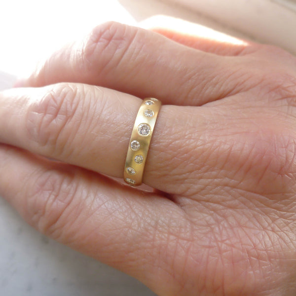 A modern unique eternity ring with 20 diamonds. Beautiful contemporary wedding, eternity or engagement ring.