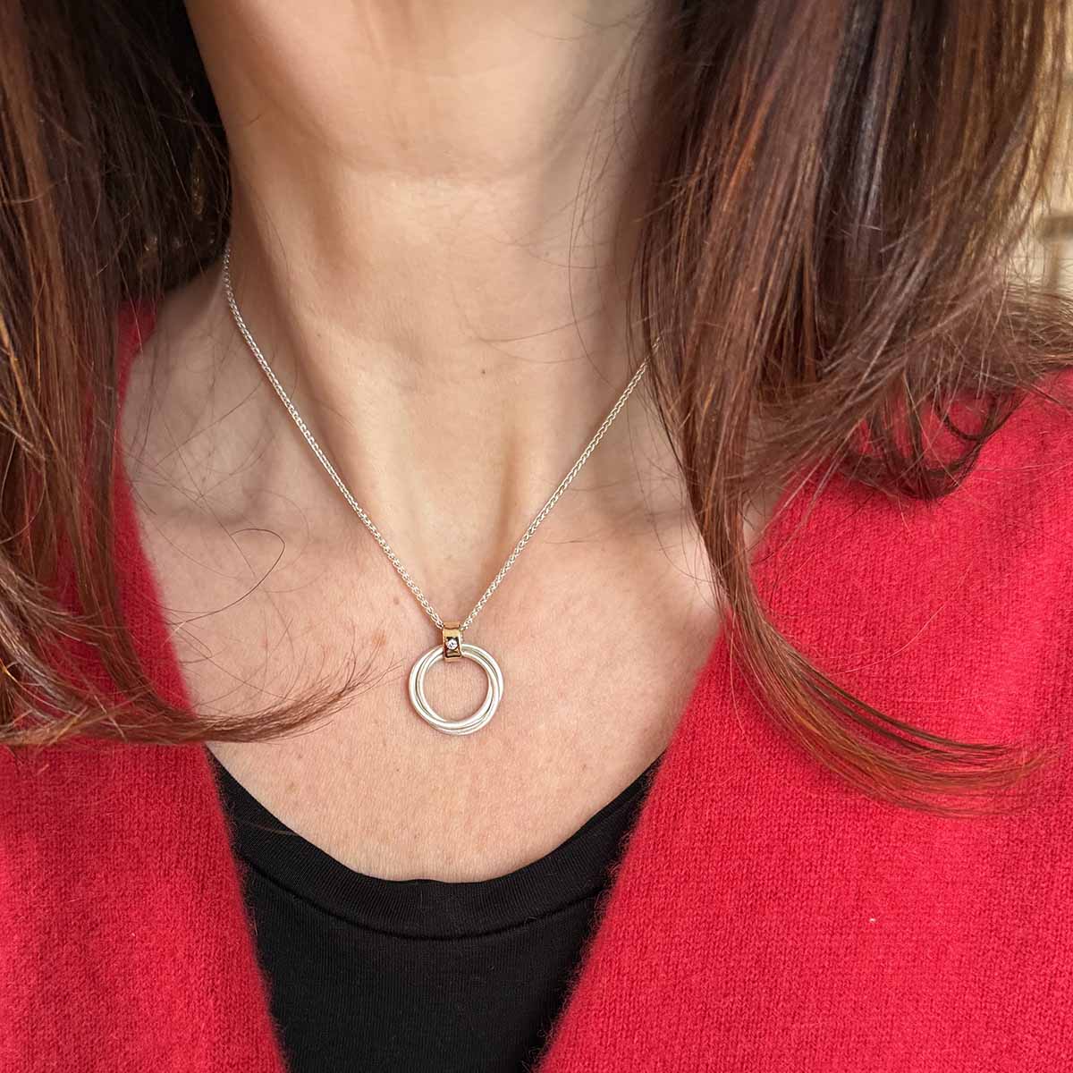 Handcrafted circle pendant with diamond in silver and gold
