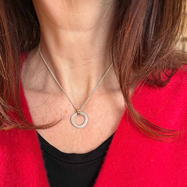 Handcrafted circle pendant with diamond in silver and gold