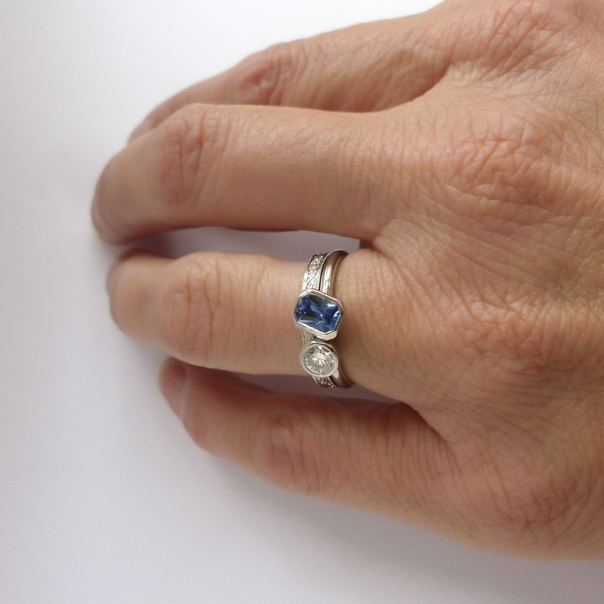 Contemporary platinum blue sapphire and diamond stacking engagement ring toi et moi