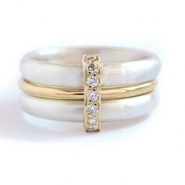 Contemporary treble band looped 18ct gold and diamond ring. Multi banded.