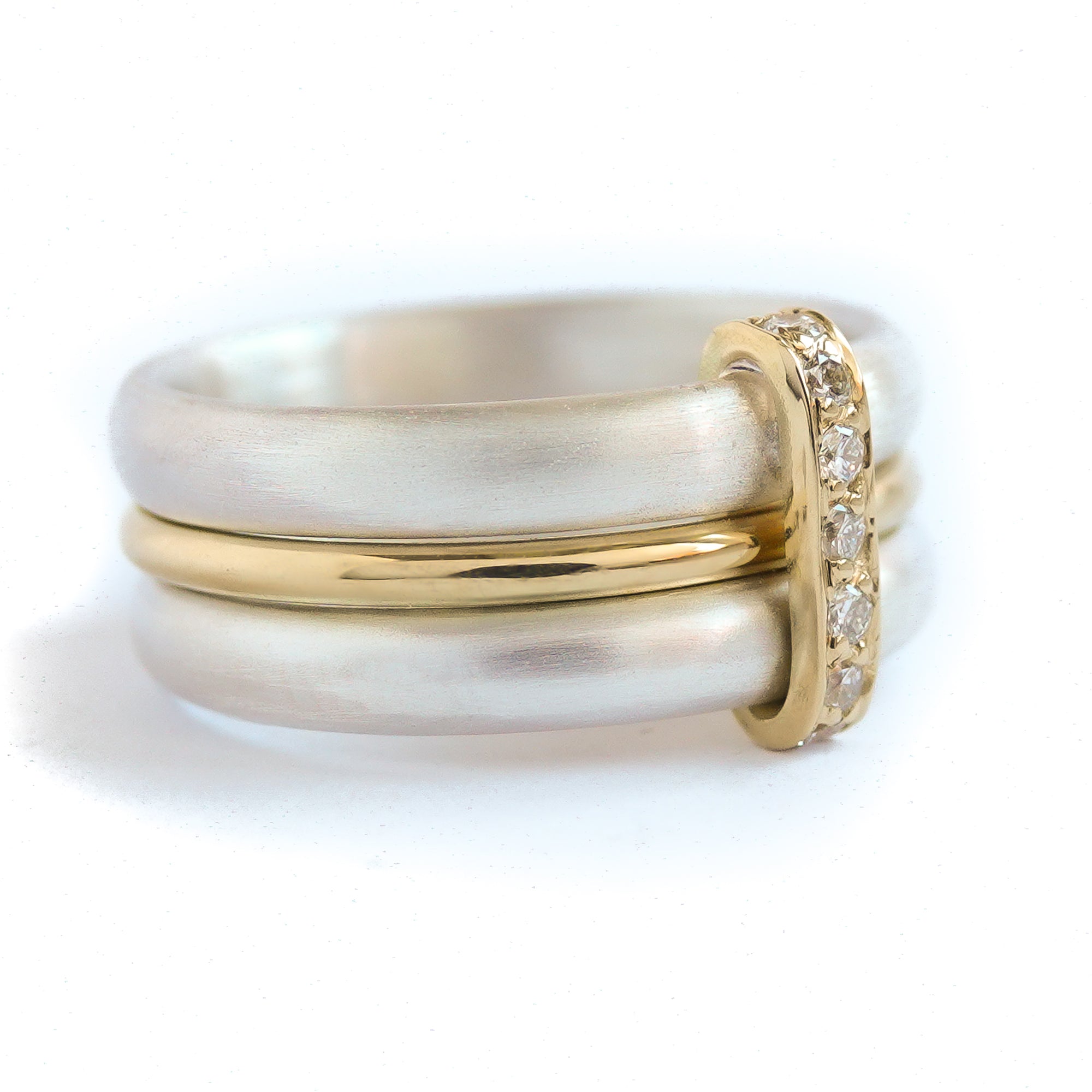 Contemporary treble band looped 18ct gold and diamond ring. Multi banded.