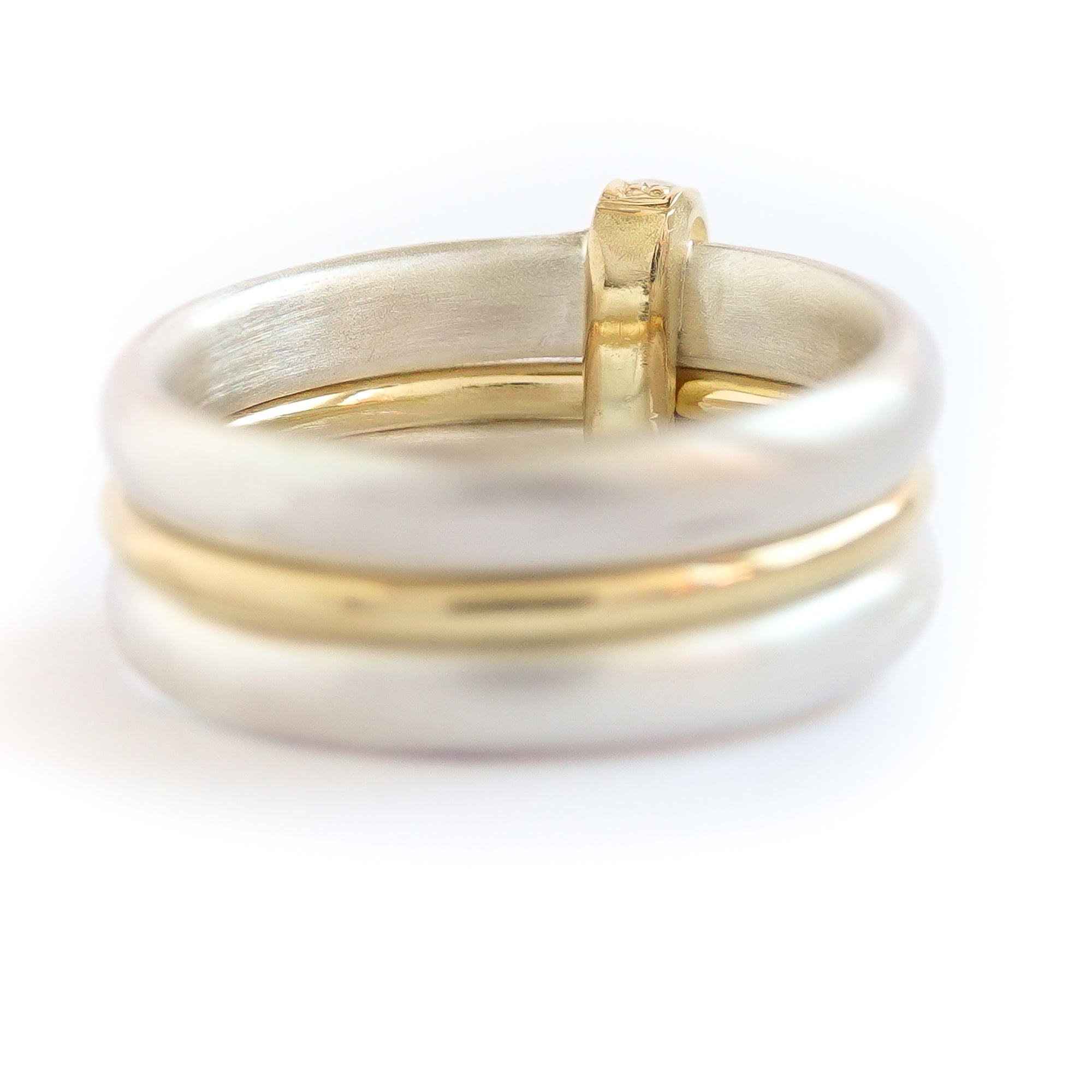 Contemporary treble band looped 18ct gold and diamond ring. Multi banded.