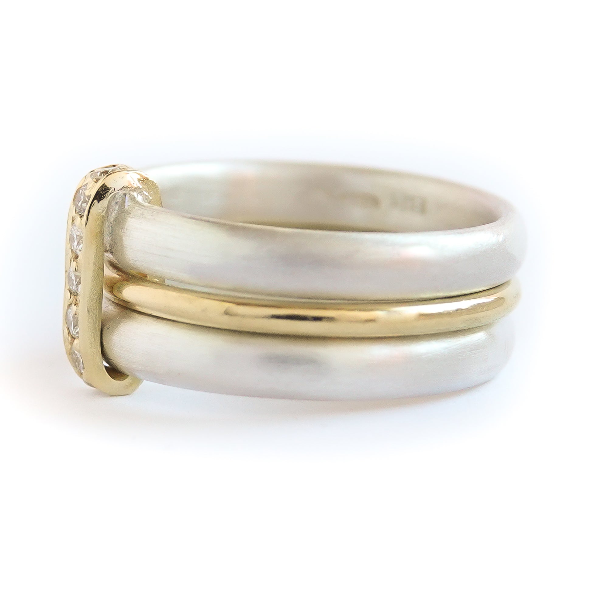 Contemporary treble band looped 18ct gold and diamond ring. Multi banded.