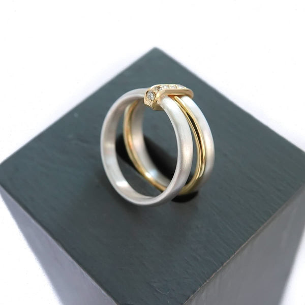 Contemporary treble band looped 18ct gold and diamond ring. Multi banded.