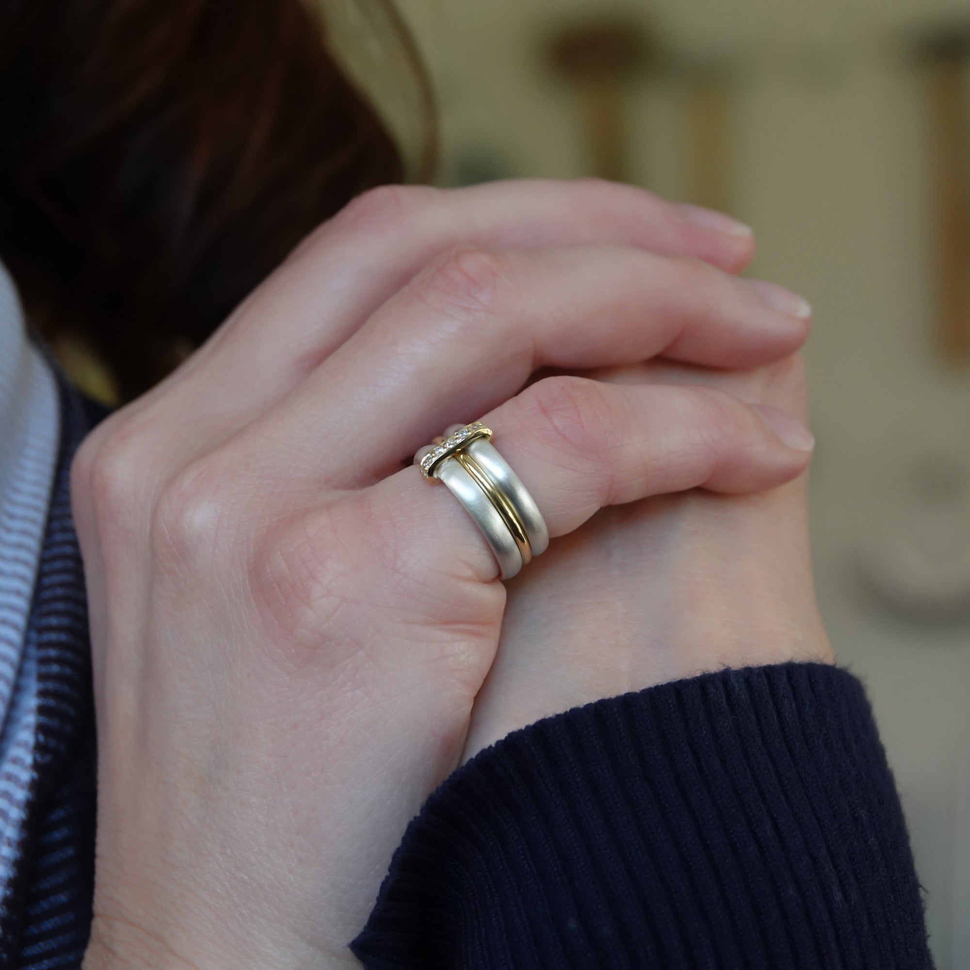 Contemporary treble band looped 18ct gold and diamond ring. Multi banded.