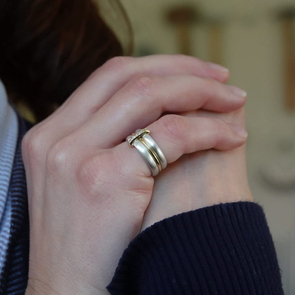 Contemporary treble band looped 18ct gold and diamond ring. Multi banded.