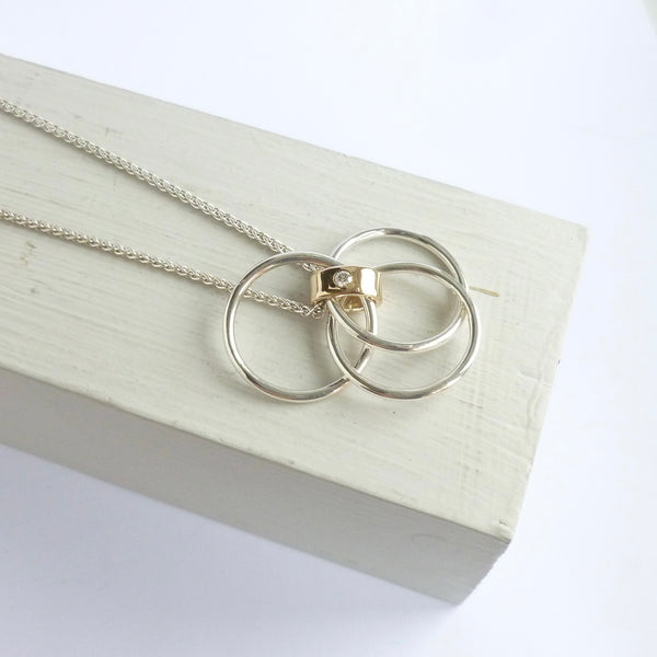 Necklace with interlocking rings on a white surface