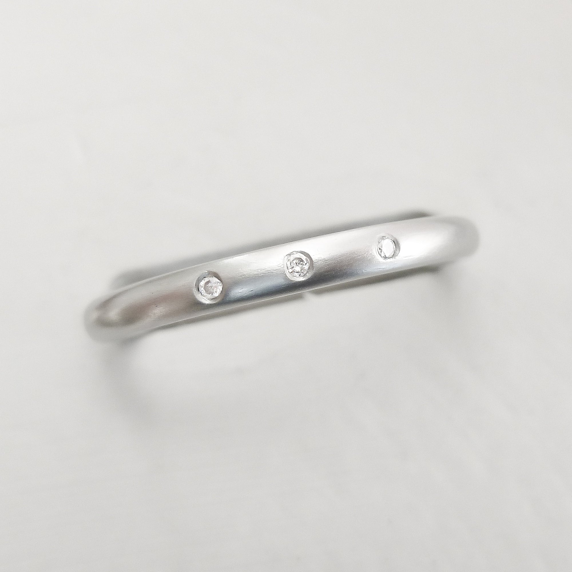 Simple elegant contemporary modern platinum and diamond wedding ring handmade by Sue Lane