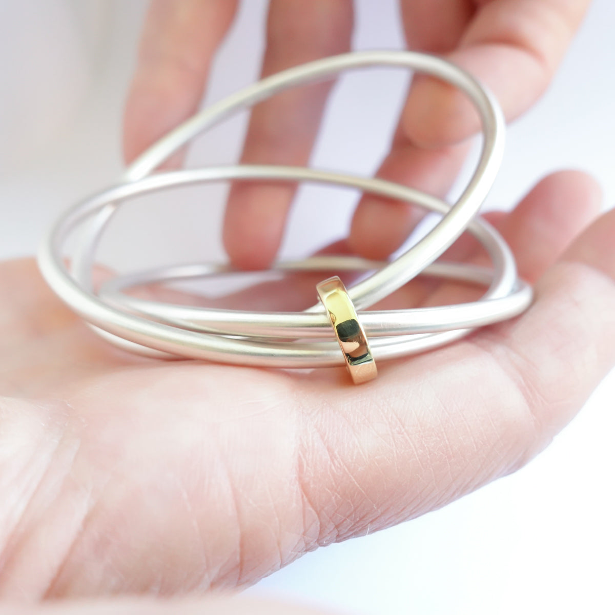 Unusual, unique, bespoke and modern silver and gold Russian style bangle with brushed finish. Handmade by Sue Lane Jewellery in Herefordshire, UK