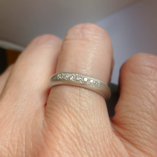 Handmade white gold wedding band for women featuring a 4mm wide D-shaped profile.
