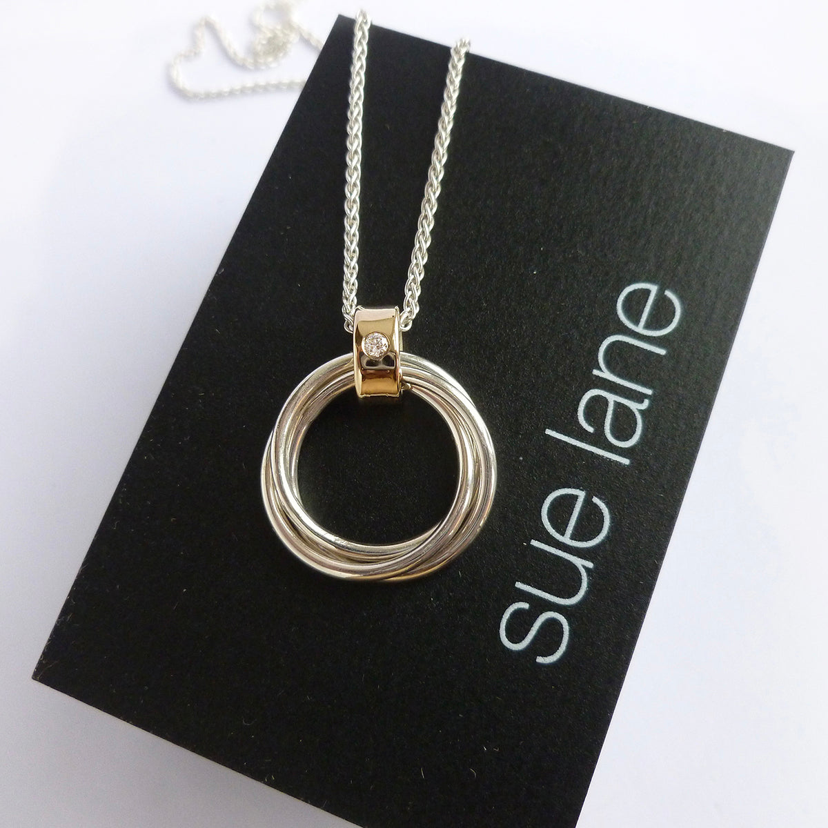 Contemporary Russian ring necklace in sterling silver with 9ct gold loop and flush set diamond by Sue Lane