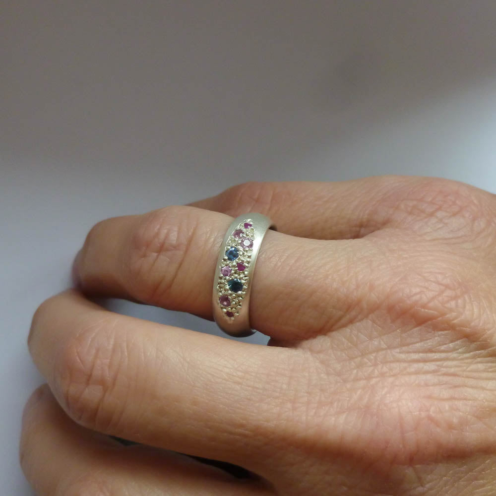 Modern silver dress ring set with pink and blue sapphires, handmade by Sue Lane Jewellery in the UK