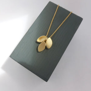 Modern and simple yellow gold leaf contemporary necklace handmade by Sue Lane UK