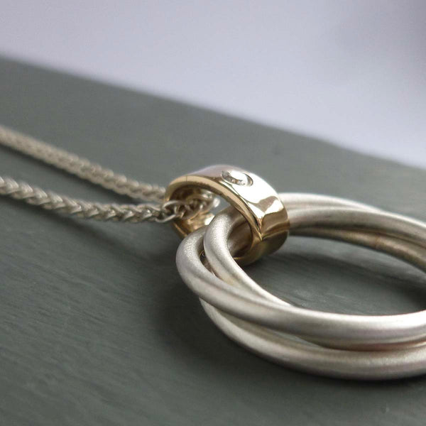 modern two tone silver and gold multi band circle pendant handmade in England 