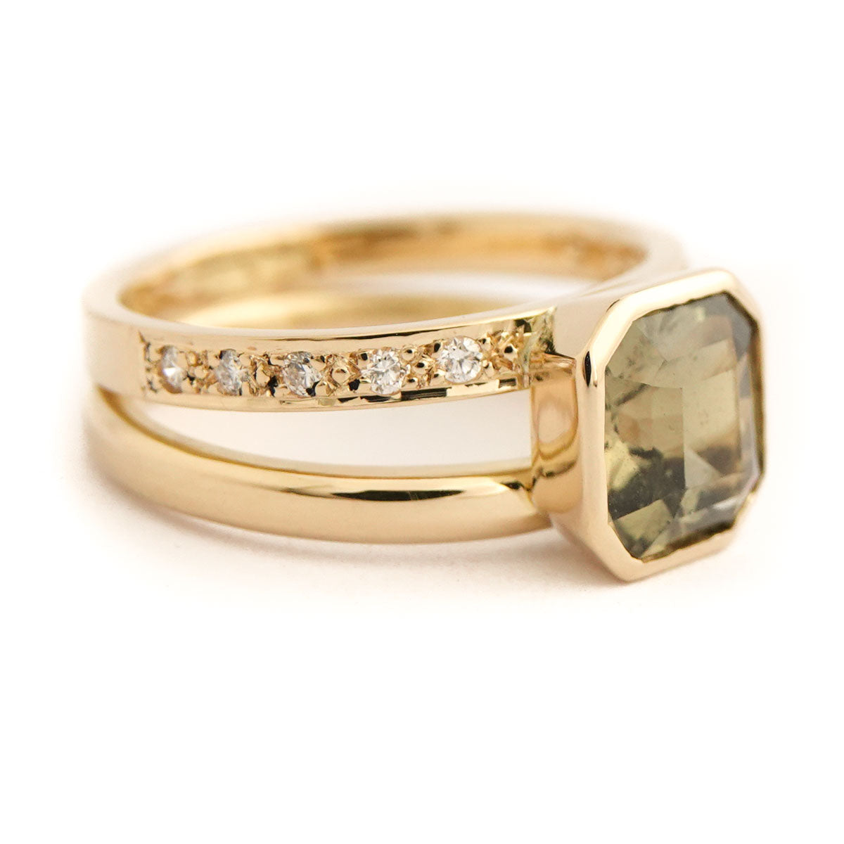 Modern handmade ring featuring 2.50ct olive green sapphire in double band gold design