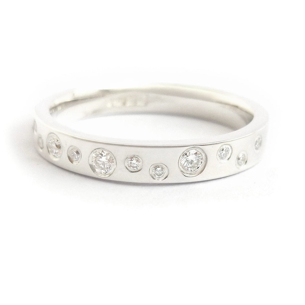 Modern silver ring featuring 12 flush set diamonds, artisan crafted
