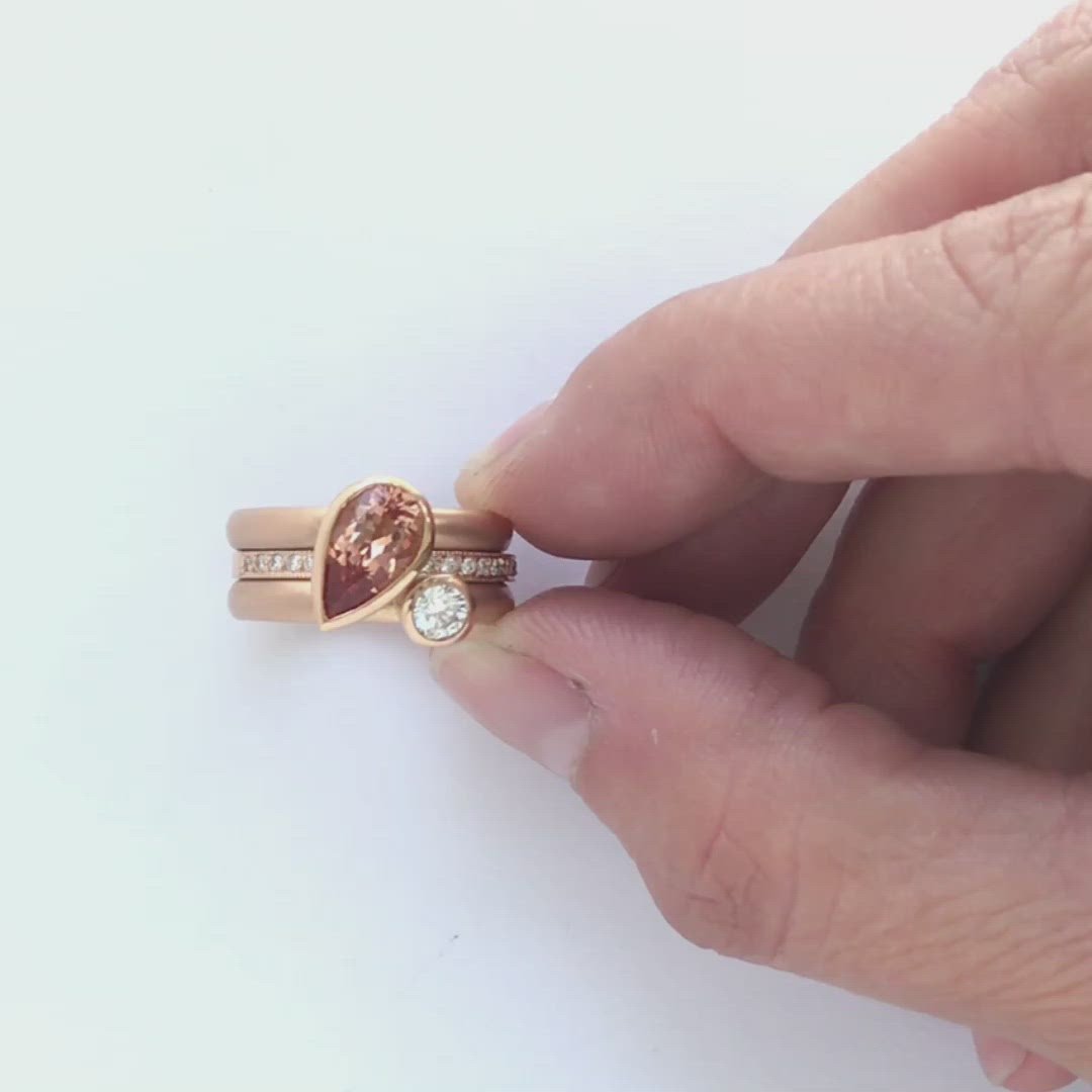 Contemporary rose gold and pear shaped imperial topaz stacking interlocking ring set.