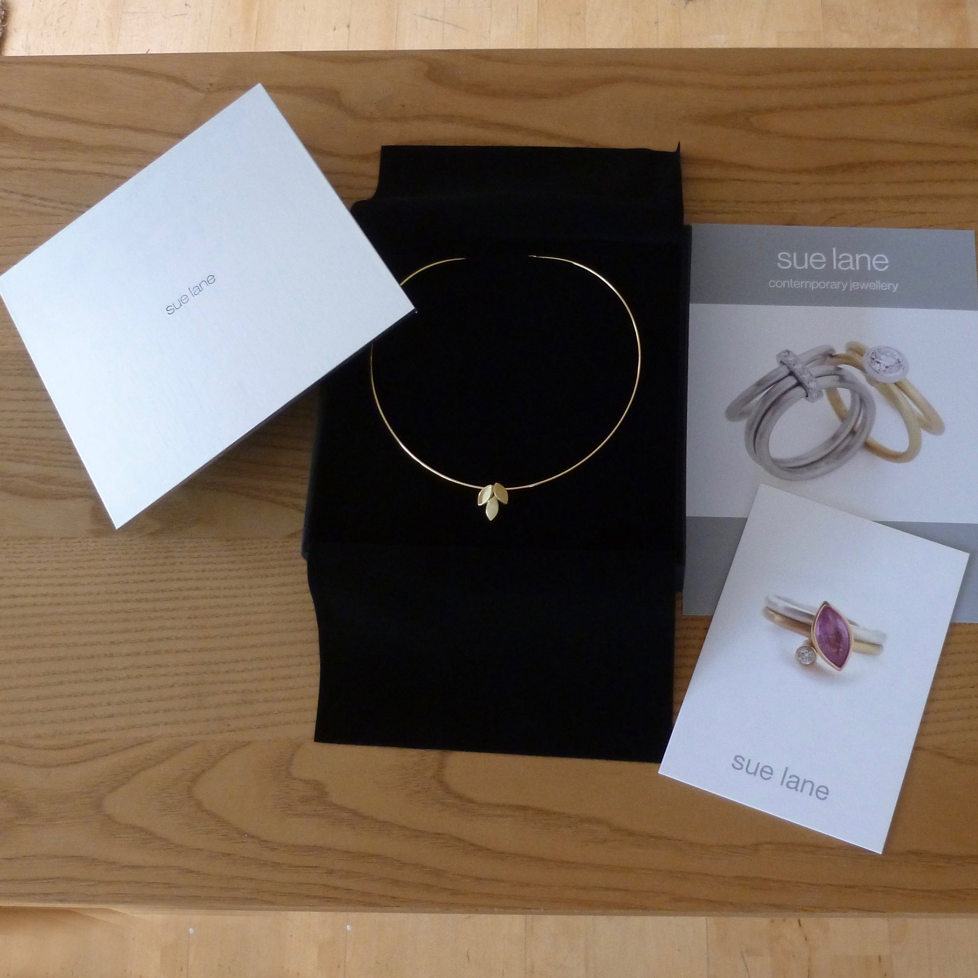 modern and simple yellow gold leaf inspired necklace handmade by Sue Lane UK