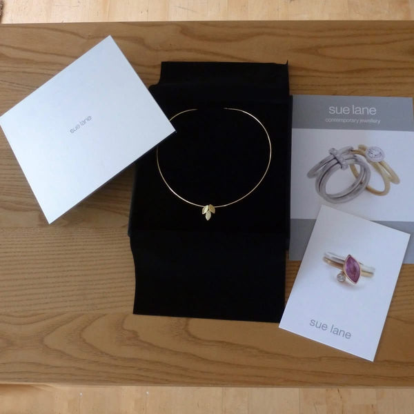 modern and simple yellow gold leaf inspired necklace handmade by Sue Lane UK