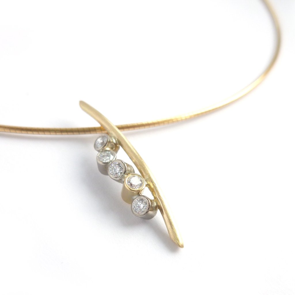 A modern two tone gold and diamond necklace / pendant with a soft necklet
