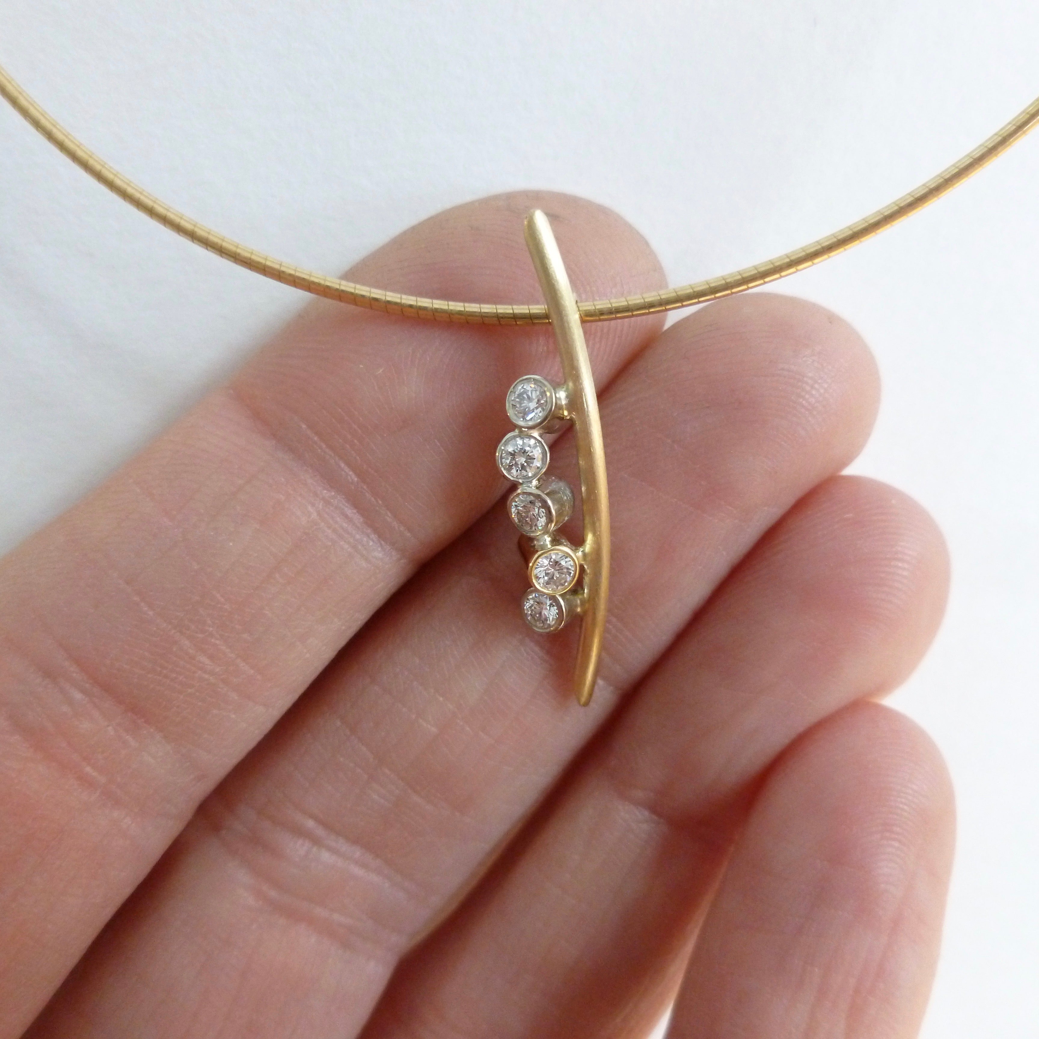 A modern two tone gold and diamond necklace / pendant with a soft necklet