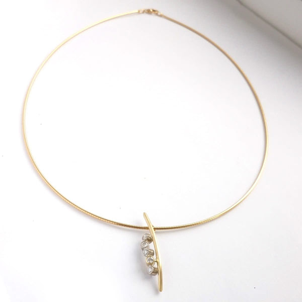 A modern two tone gold and diamond necklace / pendant with a soft necklet