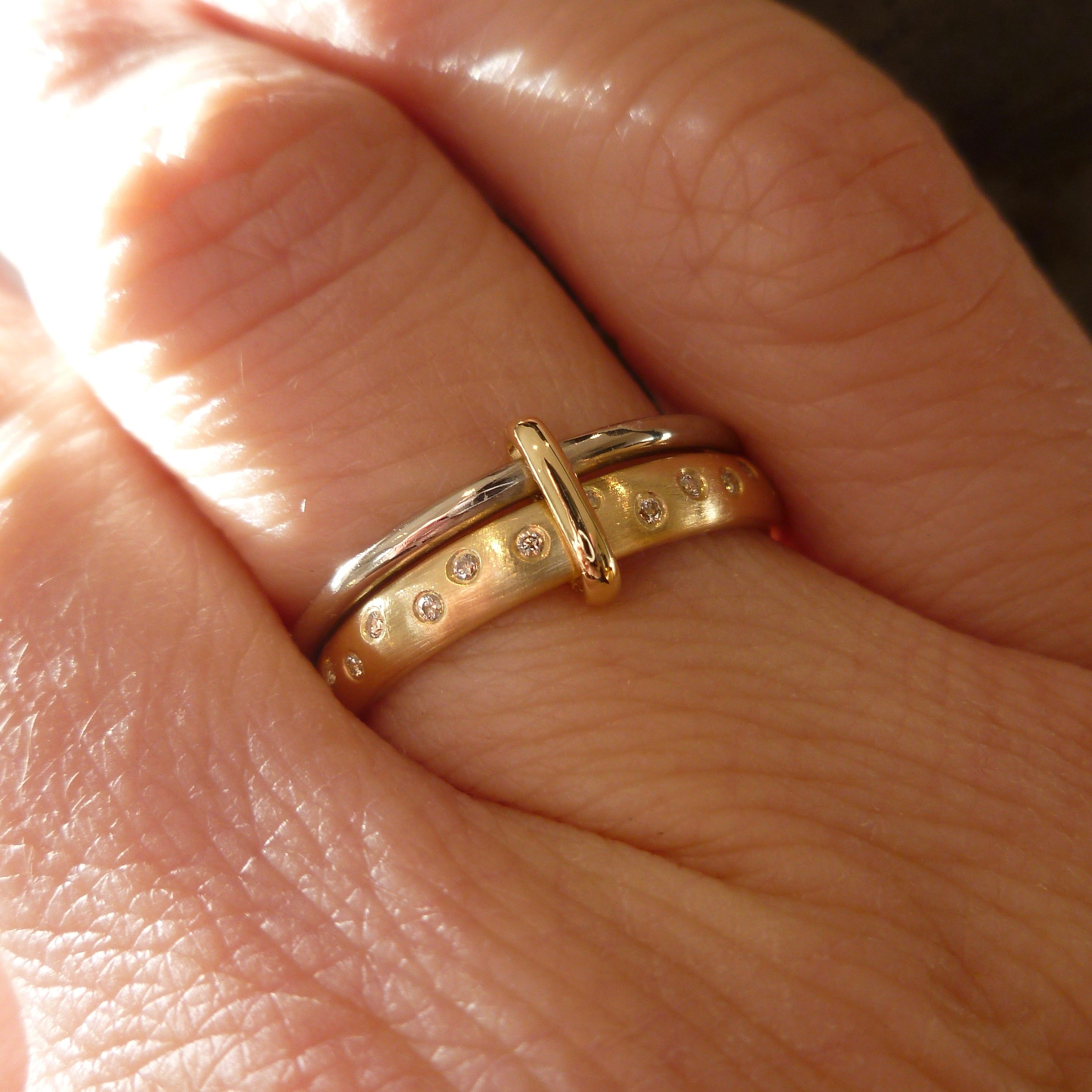 Modern, unique two band ring joined together with diamonds. An alternative eternity or wedding ring. Multi band ring or interlocking ring, sometimes called double band ring too.