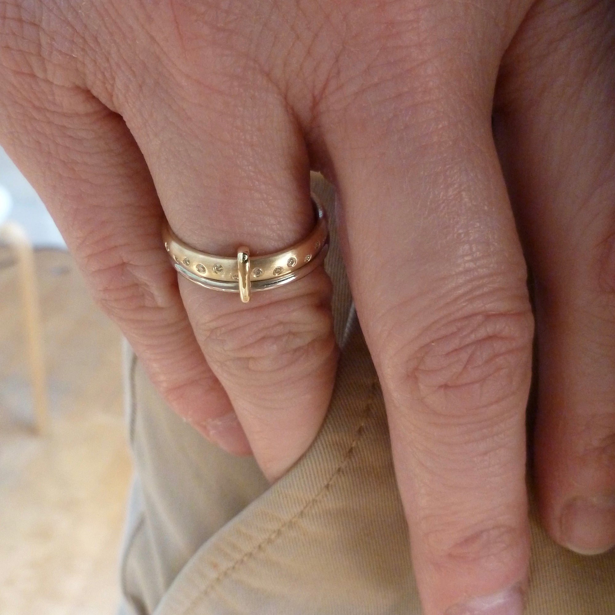Modern, unique two band ring joined together with diamonds. An alternative eternity or wedding ring. Multi band ring or interlocking ring, sometimes called double band ring too.