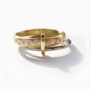 Modern, unique two band ring joined together with diamonds. An alternative eternity or wedding ring. Multi band ring or interlocking ring, sometimes called double band ring too.