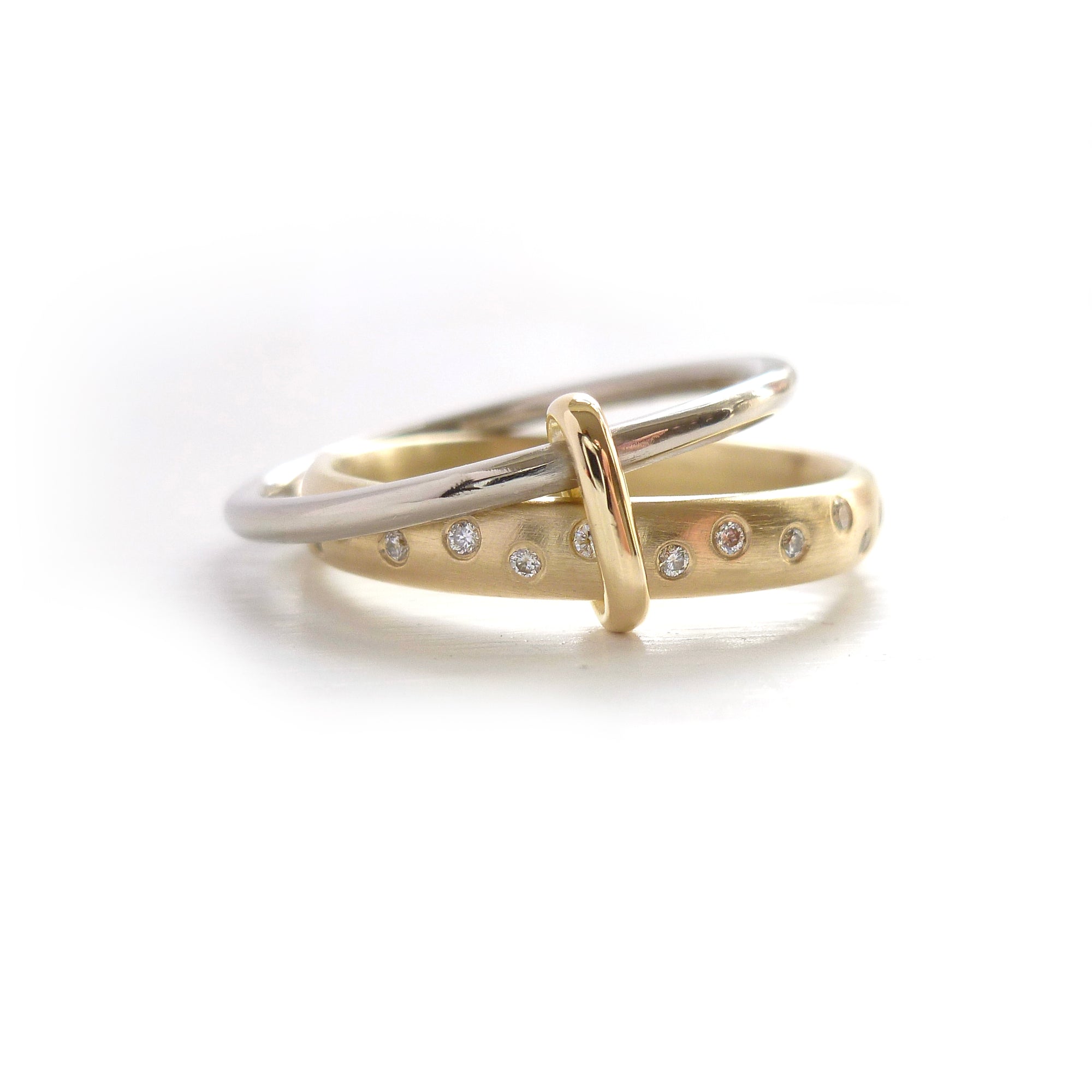 Modern, unique two band ring joined together with diamonds. An alternative eternity or wedding ring. Multi band ring or interlocking ring, sometimes called double band ring too.