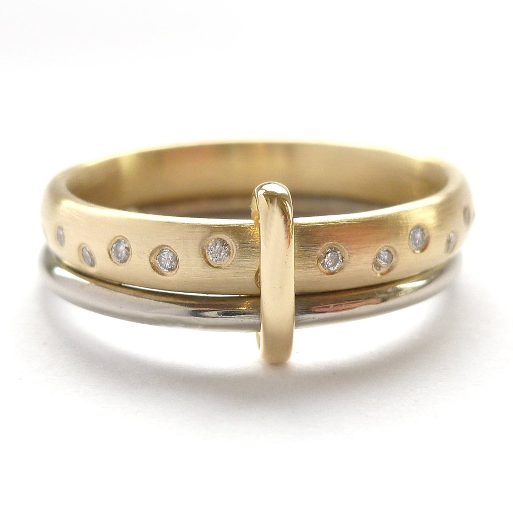 Modern, unique two band ring joined together with diamonds. An alternative eternity or wedding ring. Multi band ring or interlocking ring, sometimes called double band ring too.