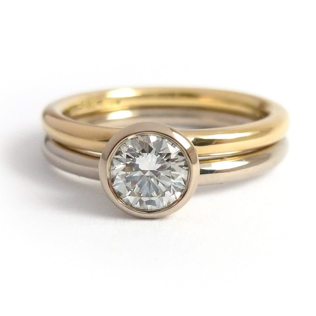 Modern, contemporary two band ring in 18ct white and yellow gold with large diamond. Multi band ring or interlocking ring, sometimes called double band ring too.