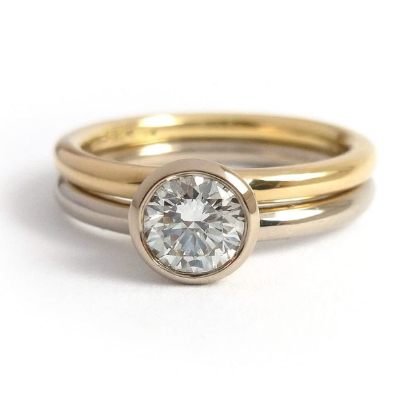 Modern, contemporary two band ring in 18ct white and yellow gold with large diamond. Multi band ring or interlocking ring, sometimes called double band ring too.