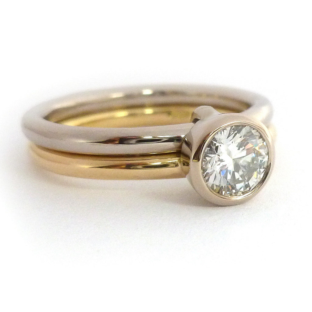 Modern, contemporary two band ring in 18ct white and yellow gold with large diamond. Multi band ring or interlocking ring, sometimes called double band ring too.