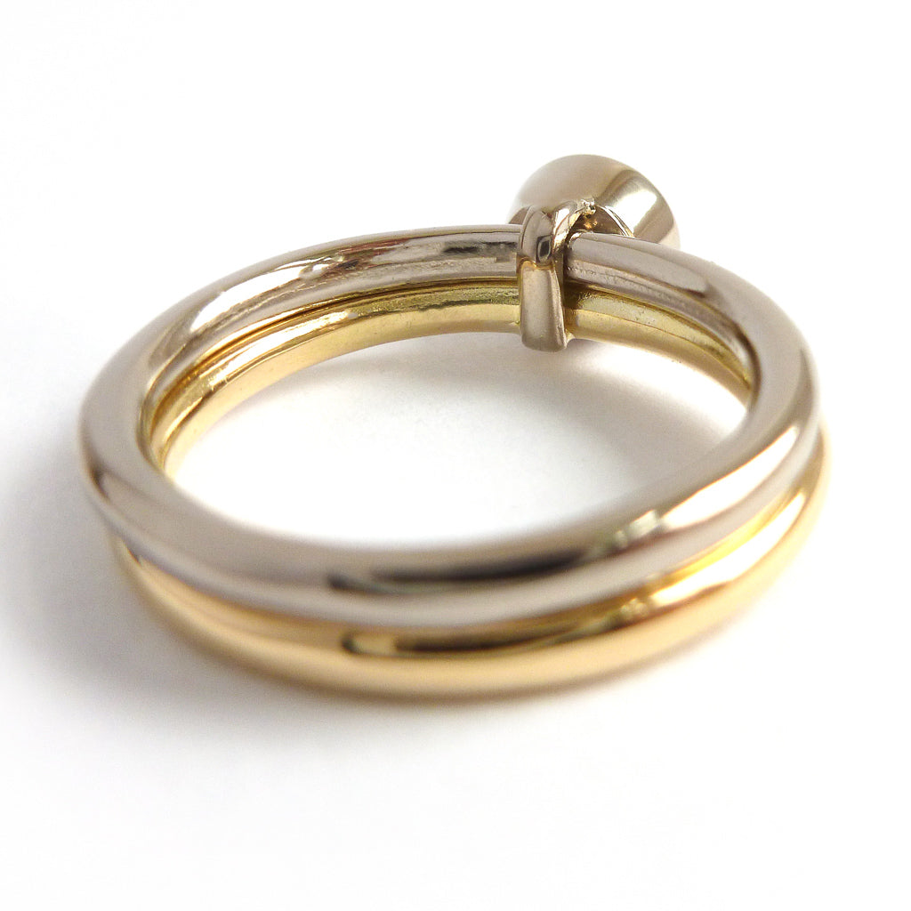 Modern, contemporary two band ring in 18ct white and yellow gold with large diamond. Multi band ring or interlocking ring, sometimes called double band ring too.