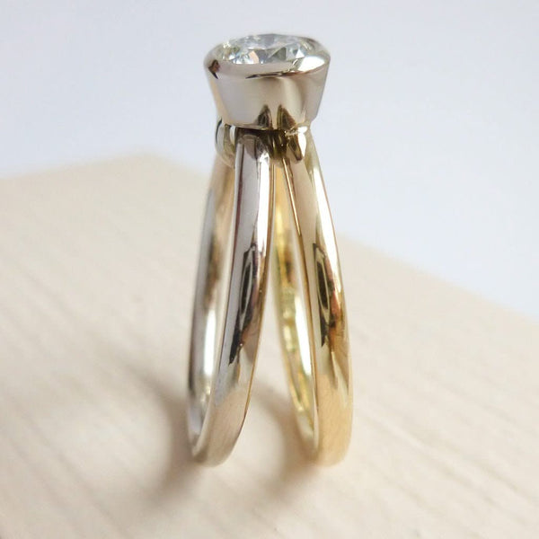 Modern, contemporary two band ring in 18ct white and yellow gold with large diamond. Multi band ring or interlocking ring, sometimes called double band ring too.