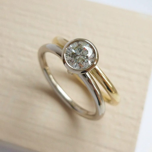 Modern, contemporary two band ring in 18ct white and yellow gold with large diamond. Multi band ring or interlocking ring, sometimes called double band ring too.