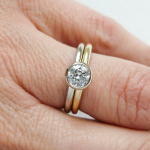 Modern, contemporary two band ring in 18ct white and yellow gold with large diamond. Multi band ring or interlocking ring, sometimes called double band ring too.