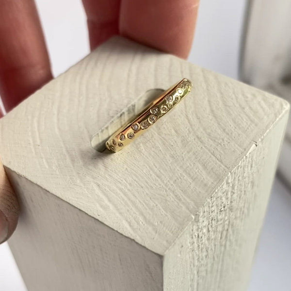 A modern contemporary gold eternity wedding engagement ring sue lane