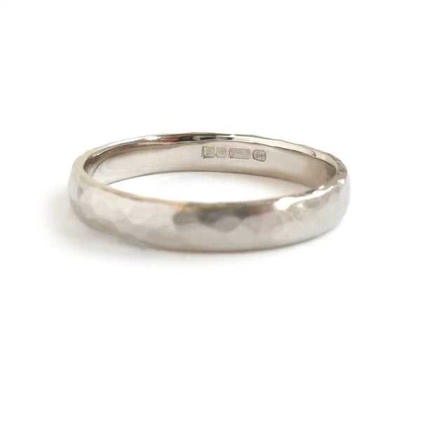 Contemporary, modern and bespoke hammered white gold wedding ring by designer maker Sue Lane Jewellery. Perfect wedding ring for men or women.