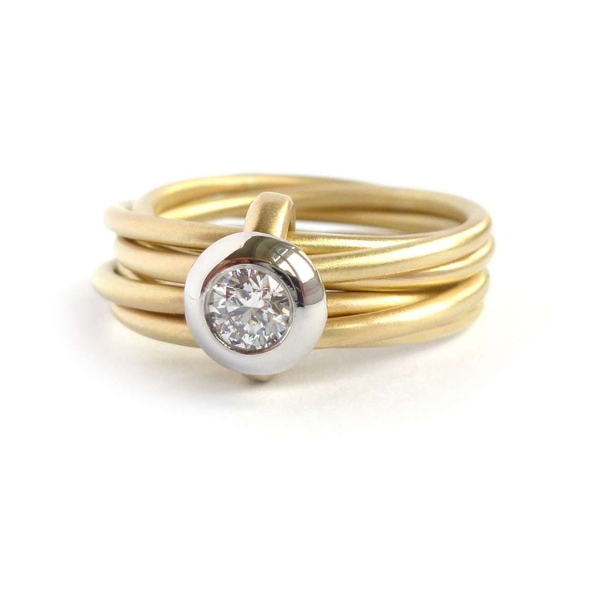 Contemporary, bespoke and modern yellow gold multi band engagement wedding ring, 0.25pt round white diamond, handmade by designer maker sue lane jewellery. Multi band ring or interlocking ring.