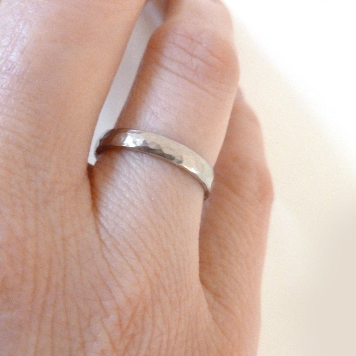 Contemporary, modern and bespoke hammered white gold wedding ring by designer maker Sue Lane Jewellery. Perfect wedding ring for men or women.